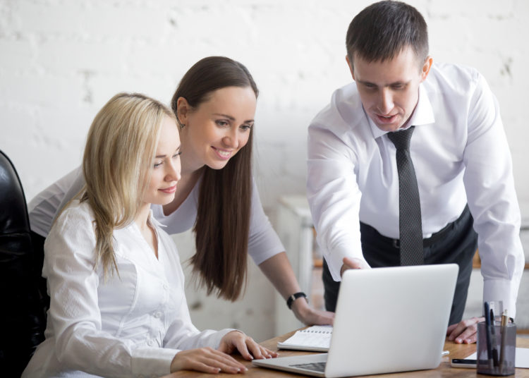 PC laptop and three people 