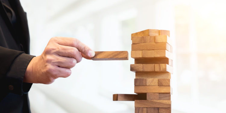 A man putting wooden blocks on the table