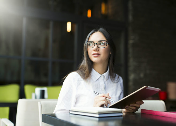 Woman reading the book in the coffee shop in the UK