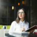 Woman reading the book in the coffee shop in the UK
