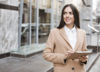 Woman with Ipad in the werehouse working with stock management application