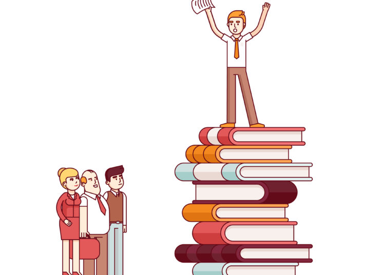 Person standing on books while doing public speaking 