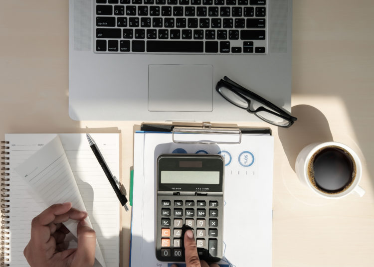 Close up businessman using calculator on documents Unrecognizabl