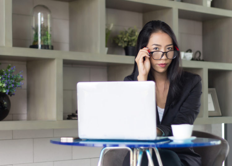 Woman Focused on Working on Her Laptop