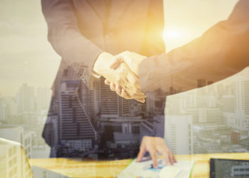 Good agreement between two Businessmen standing at the working place in city scape