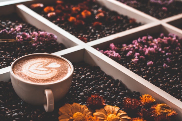 Art Coffe Cup With Coffe Beans And Flowers