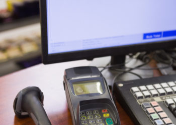 A cash register on wooden table at supermarket