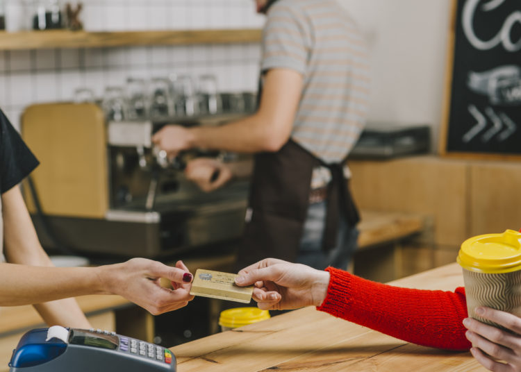 Customer paying with credit card for coffee
