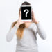 woman covered face with tablet