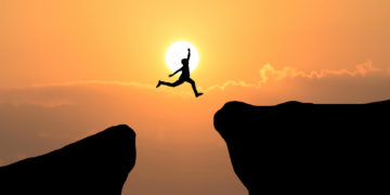 Courage Man Jump Through The Gap Between Hill ,Business Concept Idea