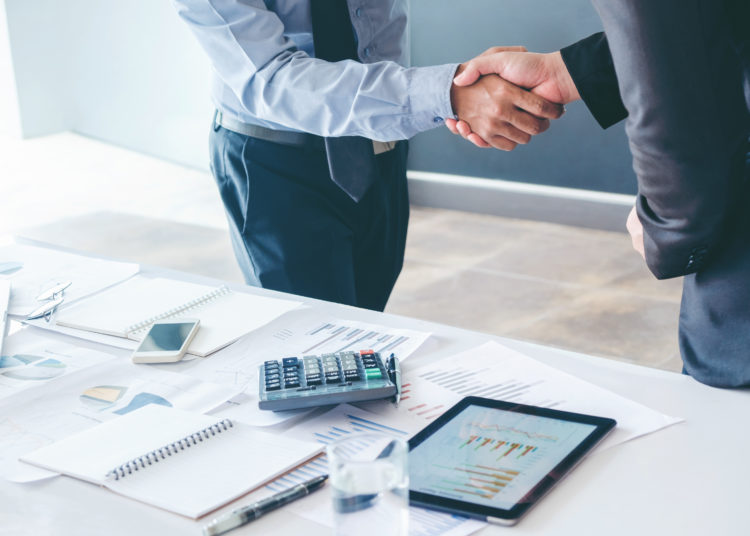 Business people colleagues shaking hands and planning Strategies