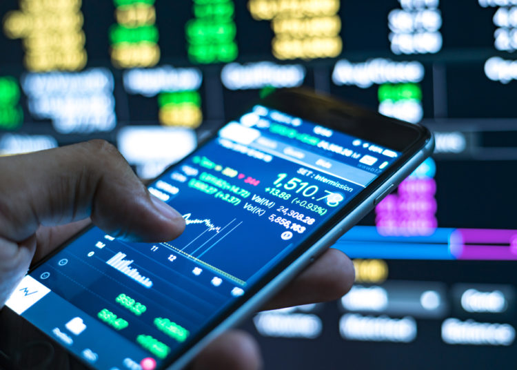 A Person Checking Stock Market Data On A Mobile Device