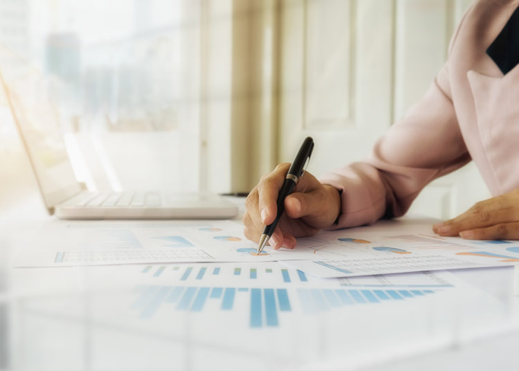 Business concept. Rows of coins for finance and banking concept with business man and woman. A metaphor of international financial consulting.