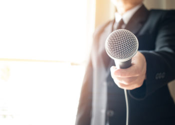 Smart businessman speech and speaking with microphones in seminar room or talking conference hall light with microphones and keynote. Speech is vocalized form of communication humans.