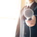 Smart businessman speech and speaking with microphones in seminar room or talking conference hall light with microphones and keynote. Speech is vocalized form of communication humans.