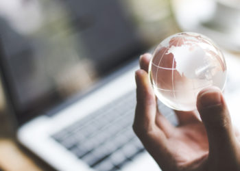 hand holding crystal world. business symbol