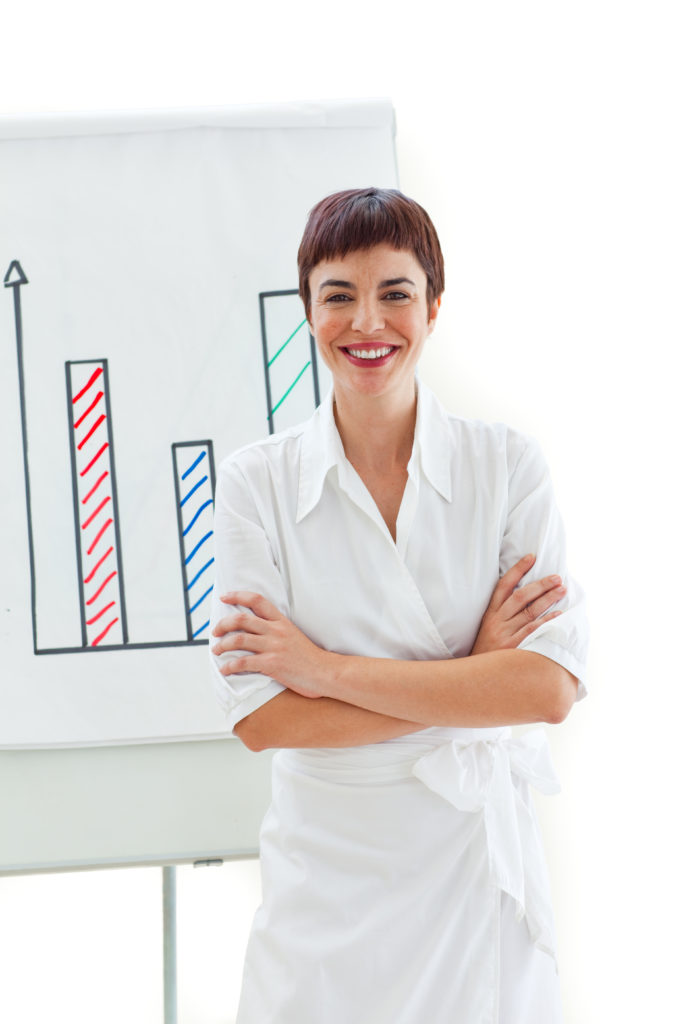 Smiling businesswoman with folded arms in front of a board against a white background