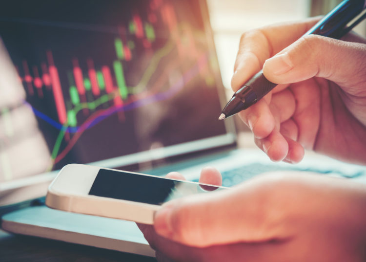 Businessman writing the trading graph of stock market