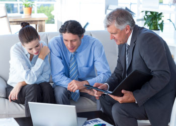 Couple in meeting with a financial adviser in living room