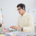 Serious designer listening music and working in his office