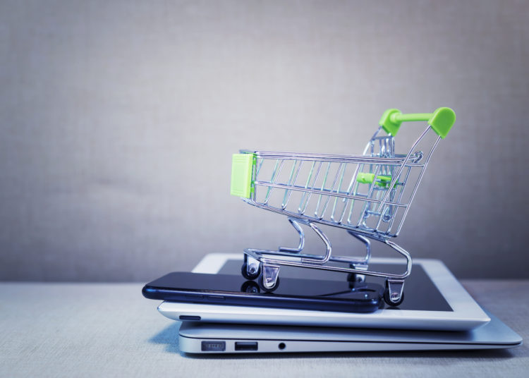 Shopping basket on top of items of online network connection. Selling and payment concept.