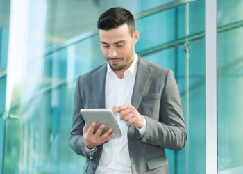 Businessman using his tablet computer software
