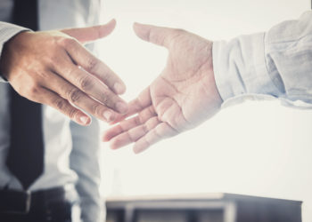 Handshake after good cooperation, Two Businessman handshake after discussing good deal of Trading contract and new projects for the company of real estate, Meeting and greeting concept.