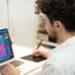 handsome hipster modern man designer working home using laptop at home
