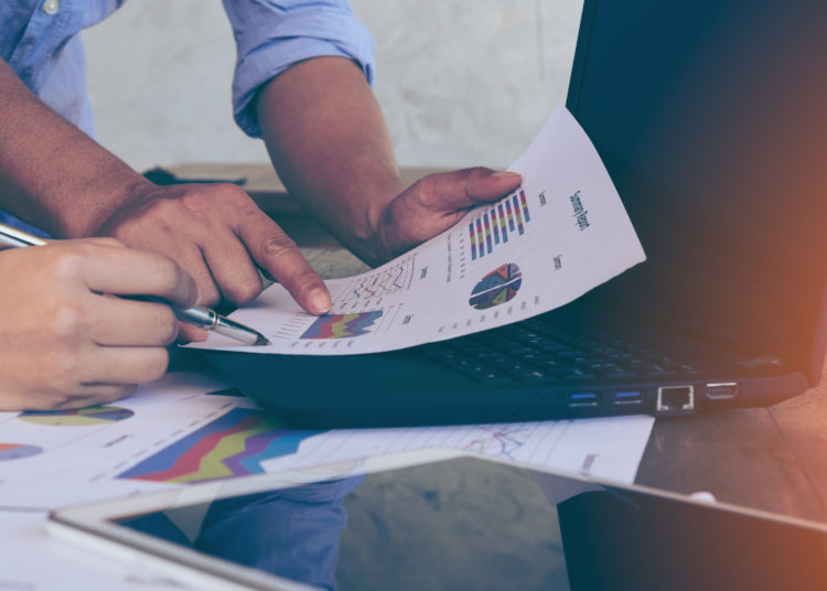 Business people brainstorming at office desk, financial adviser