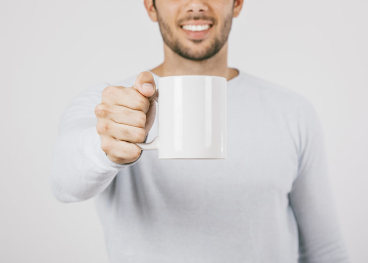 Smiling man with a mug, promotional product for company