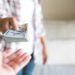 Soft focus on woman hands proposing money us dollar bills to you.