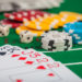 Poker chips on table in casino. Cards on green felt casino table