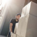 Delivery man unloading cardboard boxes