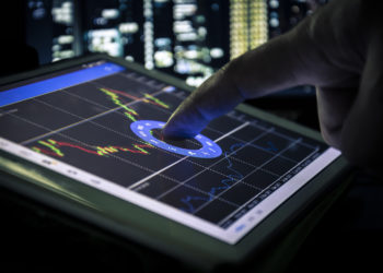 candlestick graph on tablet , Business and financial concept