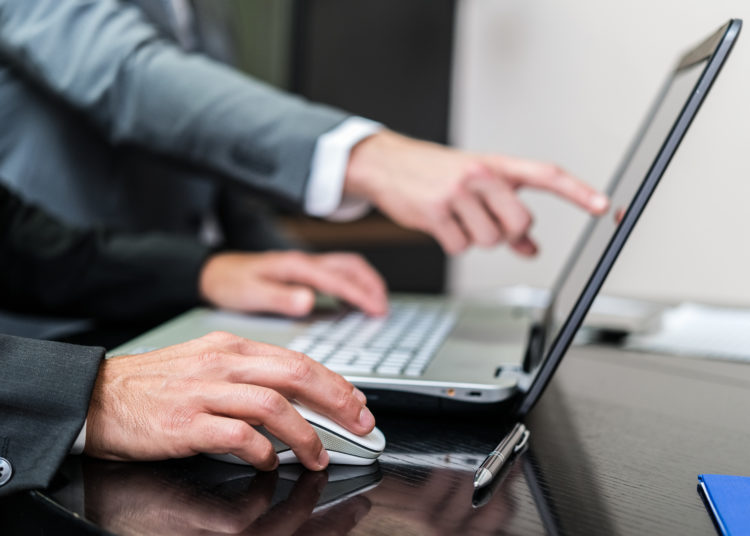 Businessmen working on laptop.