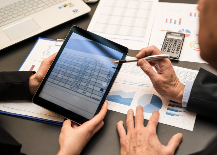 Business people using a digital tablet