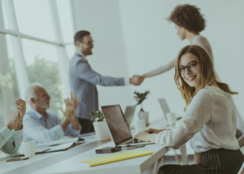 Young businesspeople shaking hands in the office when finishing successful meeting.