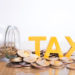 TAX Concept.Word tax put on coins and glass bottles with coins inside on white background.