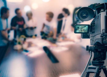 Video camera taking live video streaming at people working background