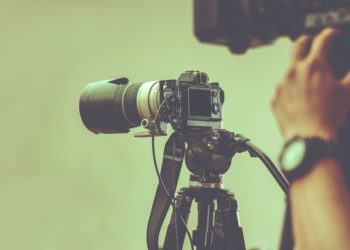 professional video camera with tripod stand by for shooting in studio production