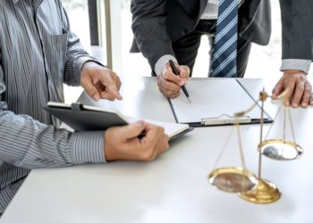 Male lawyer or Counselor working in courtroom have meeting with client are consultation with contract papers of real estate, Law and Legal services concept.