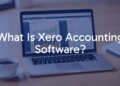 A modern laptop displaying Xero accounting software interface, clean and professional, with financial charts and graphs visible, workspace with coffee cup and notebook, bright and organized, digital finance theme.